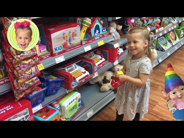 Little girl’s fun day out  doing shopping at the supermarket / toys