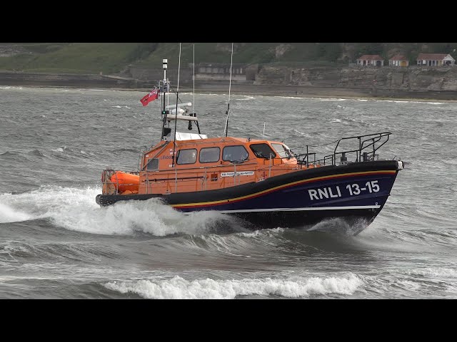 Lifeboat launches into the sea, and gets recovered by a large tractor